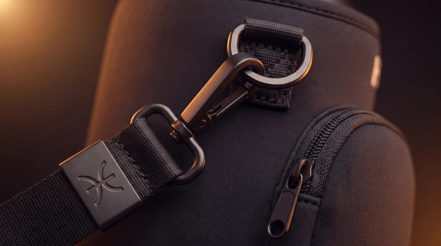 Close-up of matte hardware and raised silicone branding on the HADEED carrier